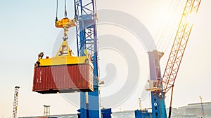 Container loading in a Cargo freight ship with industrial crane. Container ship in import and export business logistic company. In