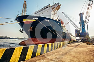 Container loading in a Cargo freight ship with industrial crane. Container ship in import and export business logistic company. In