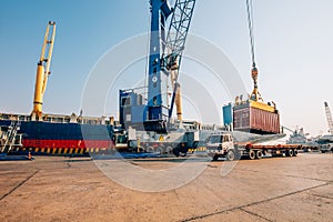 Container loading in a Cargo freight ship with industrial crane. Container ship in import and export business logistic company. In