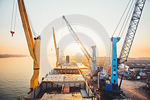 Container loading in a Cargo freight ship with industrial crane. Container ship in import and export business logistic company. In