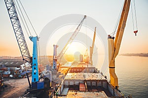 Container loading in a Cargo freight ship with industrial crane. Container ship in import and export business logistic company. In