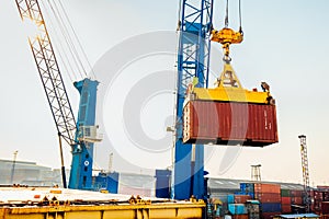 Container loading in a Cargo freight ship with industrial crane. Container ship in import and export business logistic company. In