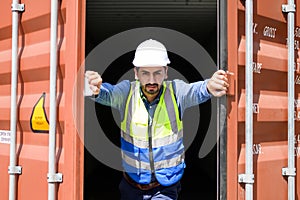 container logistic operators workers wearing yellow helmets and reflection shirts and open containers for inspection and check the
