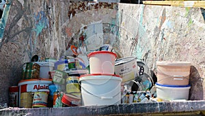 Container with old paint in a recycling center