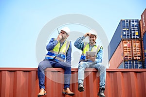 container operators wearing helmets and safety, vests control via walkie-talkie workers in container yards. Cargo Ship Import