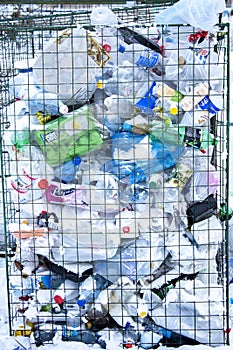 Container with plastic bottles and containers, separate waste collection concept. Krasnoyarsk, Russia, 01-01-2021- illustrative