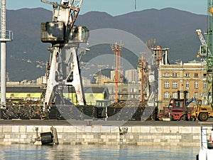 Container port view. there are cranes and operation vehicles.