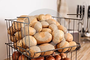 Container with potatoes and onions. Orderly storage