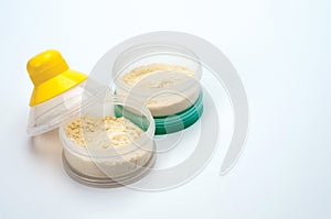 Container of powdered milk for infants on white background