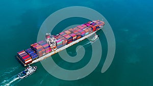 Container ship arriving in port, container ship and tug boat going to deep sea port, logistic business import export shipping and