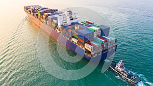 Container ship arriving in port, container ship and tug boat going to sea port, logistic business import export shipping and