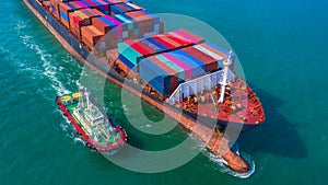 Container ship arriving in port, Tug boat and container ship going to deep sea port, logistic business import export shipping and