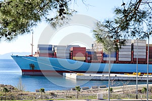 Container ship for carriage of goods with containers to shore in port ship port on horizon.