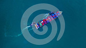Container ship carrying container for import and export, business logistic and transportation by ship in open sea, Aerial view