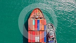 Container ship in export and import business logistics and transportation. Cargo and container box shipping to harbor by crane.