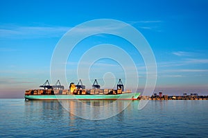 Container ship in harbor of Gdansk, Poland. Industrial scene.