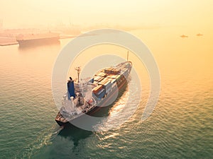 container ship in import export and business logistic, By crane, Trade Port, Shipping, cargo to harbor. Aerial view, Water