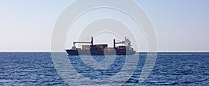 Container ship for international transport sail full of cargo. Sea commerce, sky background, banner.