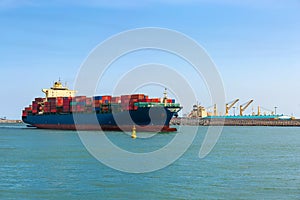Container ship loaded with containers enters the Harbor