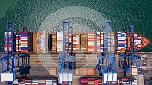 Container ship loading and unloading in deep sea port, Aerial top view of logistic import export transportation business by