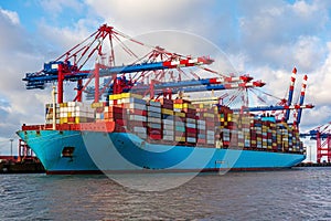 Container ship loading and unloading in port. Logistic import and export freight transportation by container ship