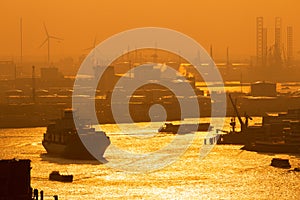 Container ship on the Meuse river in the Port of Rotterdam during sunset