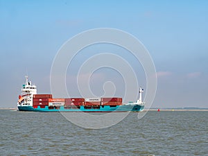 Container ship Ragna on Westerschelde in the Netherlands to port of Antwerp, Belgium