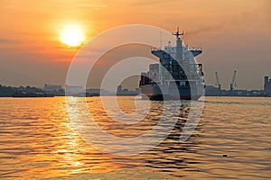 Container ship sailing at sunrise, Bangkok