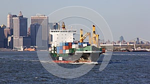 Container ship SPICA underway in New York Harbor, Lower Manhattan waterfront in the background