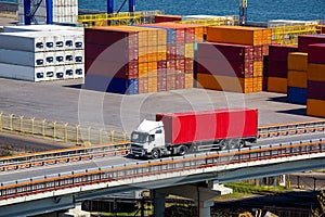 Container ship truck auto transportation of containers on the highway bridge.