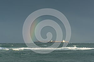 Container ships and rainbow