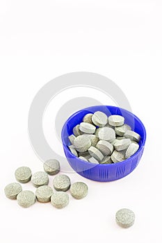 Container with spirulina pills.