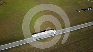 Container truck moving on highway traffic, countryside road