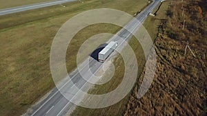 Container truck moving on highway traffic, countryside road