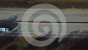 Container truck moving on highway traffic, countryside road