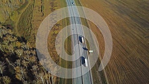 Container truck moving on highway traffic, countryside road