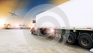 Container truck in shipping port and cargo plane flying above