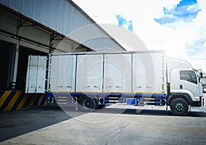 Container Trucks Loading at Dock Warehouse. Container Shipping. Freight Truck Logistics, Cargo Transport.