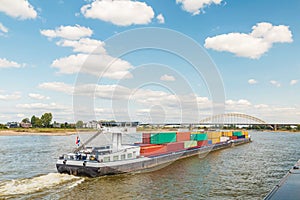 Container vessel passing the city of Nijmegen on the Dutch river Waal