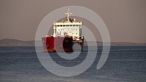 A containerized cargo ship enters the port for unloading