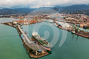 Containers in cargo freight port, aerial view from drone. Logistics, transportation, import and export goods. Industrial