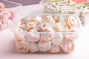 Containers with frozen  semi-finished meat products  from the refrigerator. meatballs, dumplings, chopped beans