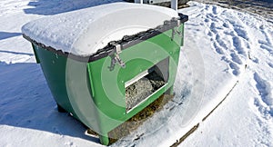 Containers with grit on the side of the road in winter service