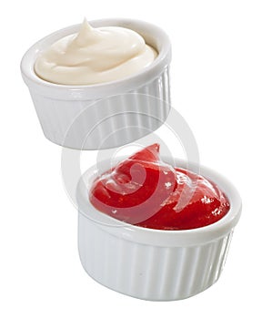 Containers of mayonnaise and tomato ketchup photo