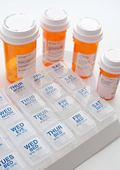 Containers with pills and weekly organizer