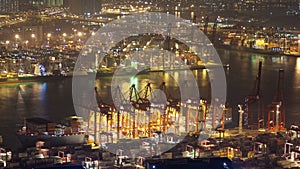 Containers Port in Hong Kong skyview at night time-lapse. pan up