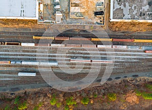 Containers in railway station in a sump many wagons and trains aerial view