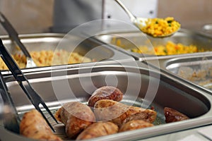 Containers with tasty food in canteen