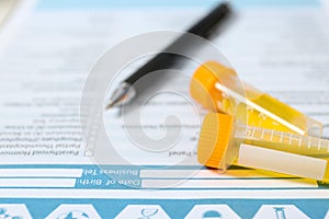 Containers with urine samples for analysis on medical report, closeup.