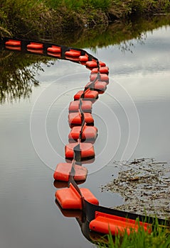 Containment Boom as Temporary Floating Barrier Used to Contain an Oil Spill. Environmental Disaster Prevention Equipment